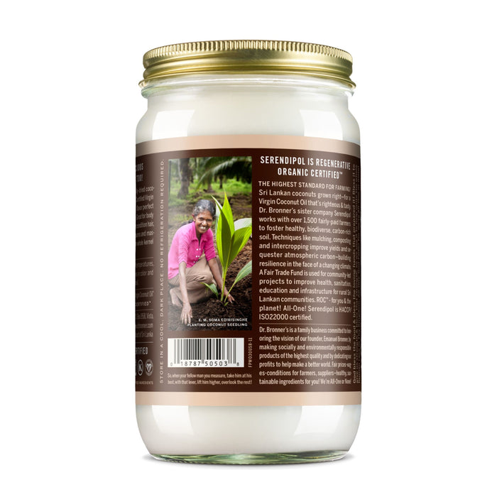 A glass jar with a gold lid contains Dr. Bronners Whole Kernel Virgin Coconut Oil. The label shows a smiling person planting a seedling and highlights its Regenerative Organic Certified status, with a barcode at the bottom.