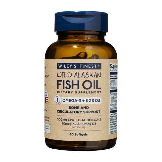 Wileys Finest Wild Alaskan Fish Oil - Omega-3 + K2 & D3 dietary supplement supports bone and circulatory health. It includes 60 softgels in an amber bottle with a navy blue cap and label.