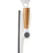 The Wipe Out Pivoting Squeegee by Full Circle, featuring a wooden handle and white rubber blade, hangs on a hook. Its modern, minimalistic design reflects eco-friendly principles.