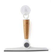 The Wipe Out Pivoting Squeegee by Full Circle features an eco-friendly light brown wooden handle, white plastic fittings, and a gray rubber blade. It includes a transparent suction cup for easy hanging, combining sustainability with practical design.