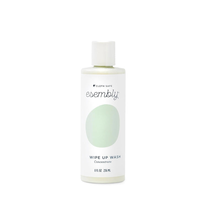 The Esembly Baby foamer bottle in white with a green label and white cap features the brand name and product description Wipe-Up Wash Refill. Its an organic foaming wipes cleanser clearly labeled as 8 fl oz or 236 mL.