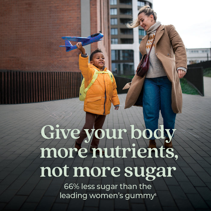 A smiling woman outdoors with a boy playing airplane. Text: Nourish your body with New Chapter Women’s Multivitamin Gummies—Berry Citrus flavor, nutrient-packed, and 66% less sugar than leading women’s multivitamin gummies.