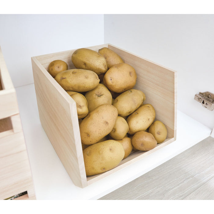 The iDesign Wood Open Front Bin, crafted from renewable Paulownia wood, holds several light brown potatoes and is perfectly placed on a white shelf.