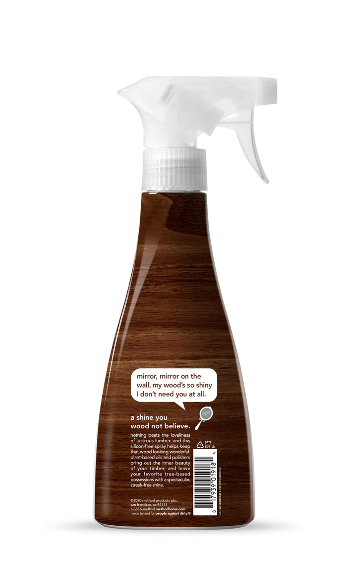 The method Wood Polish spray bottle features a wood finish design and the label: mirror, mirror on the wall, my woods natural shine means I dont need you at all, with additional text and a barcode. It comes with a white nozzle and offers a sustainable option for polishing wood.