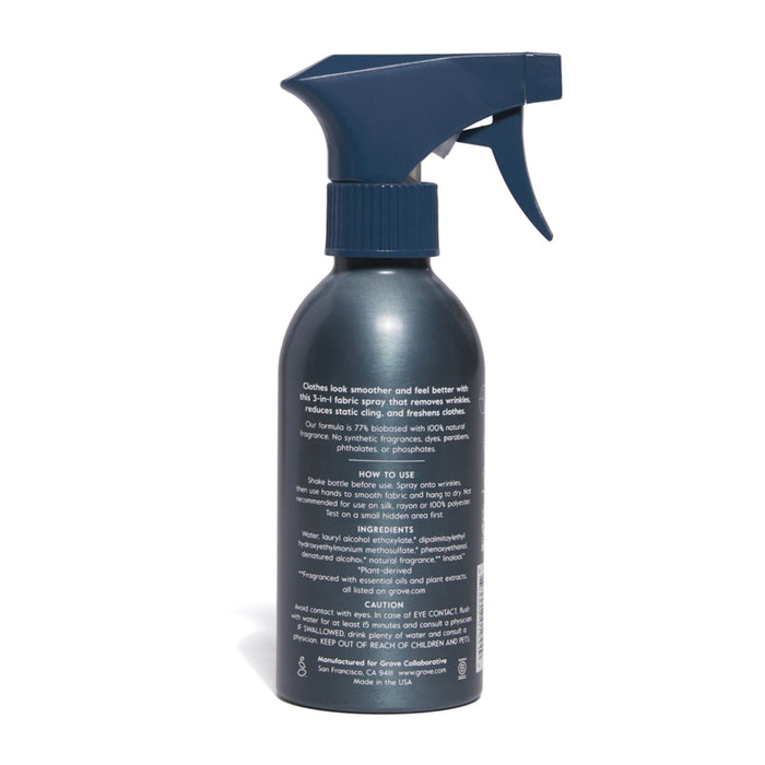 The Grove Co. 3-in-1 Wrinkle Release comes in a dark fabric spray bottle with a trigger nozzle, providing wrinkle release benefits. The back label details instructions, ingredients, and cautions in white text for a natural fragrance experience.
