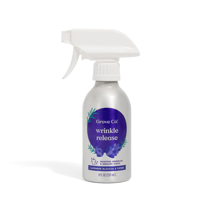A silver Grove Co. Wrinkle Release Starter Kit bottle with reusable sprayer, lavender blossom and thyme scent, eco-friendly packaging, white nozzle, purple floral label; contains 8 fl oz (237 ml).