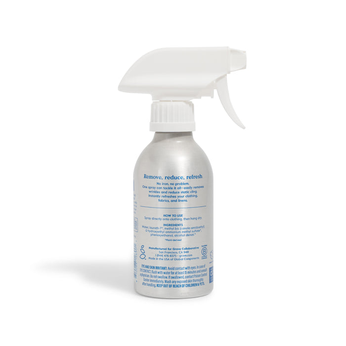 A silver Grove Co. Wrinkle Release Starter Kit spray bottle with a reusable sprayer attachment and blue product info is shown against a white background.