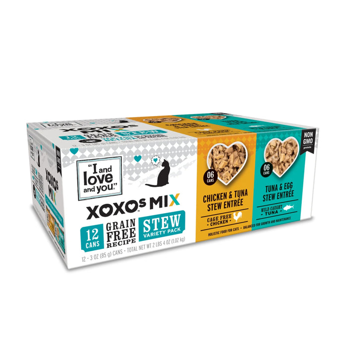 The I and Love and You XOXOs Mix Cat Food - Stew Variety Pack offers 12 grain-free cans in Chicken & Tuna and Tuna & Egg flavors, with packaging promoting non-GMO and filler-free benefits.