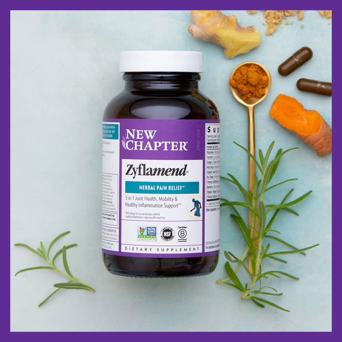 A bottle of New Chapter Zyflamend™ Herbal Pain Relief, Healthy Inflammation & Joint Support sits on a light blue surface surrounded by turmeric, ginger, capsules, and rosemary. The label emphasizes 3-in-1 Joint Health, Mobility & Inflammation Relief, reflecting its focus on joint health and comfort.